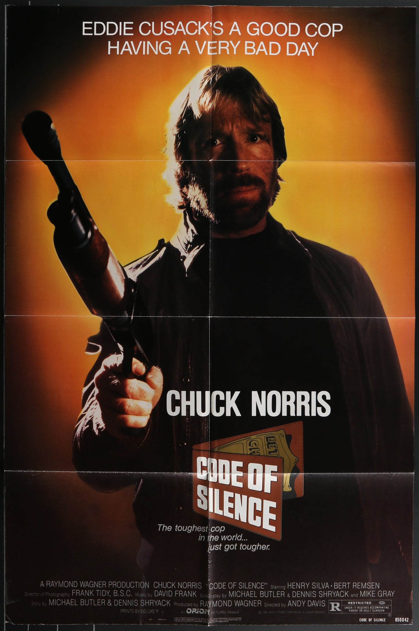 Vintage one-sheet movie poster featuring Chuck Norris in 'Code of Silence' with a yellow tinted background and a gun in his hand.