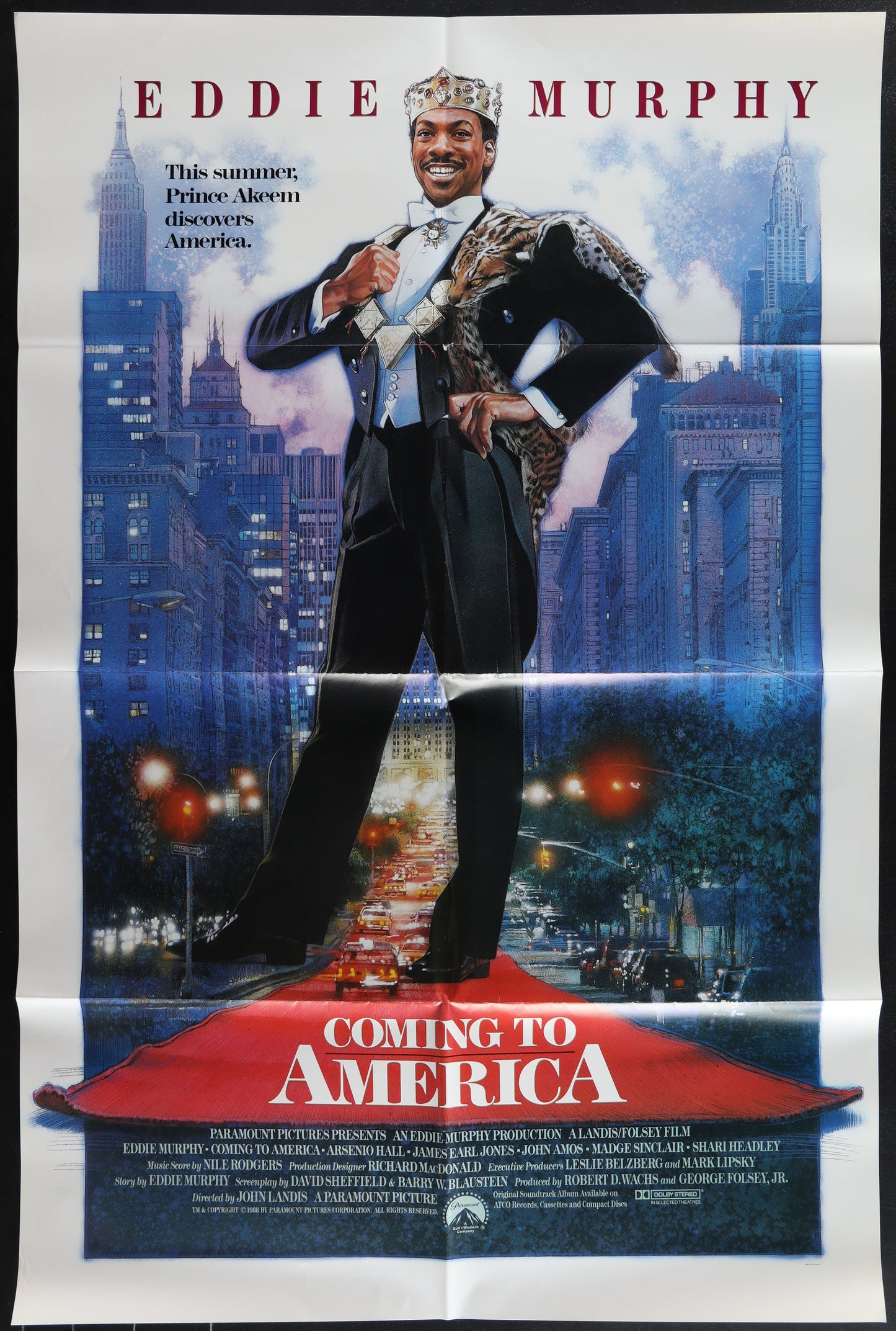 Movie poster for 'Coming to America' featuring Eddie Murphy on a city street.