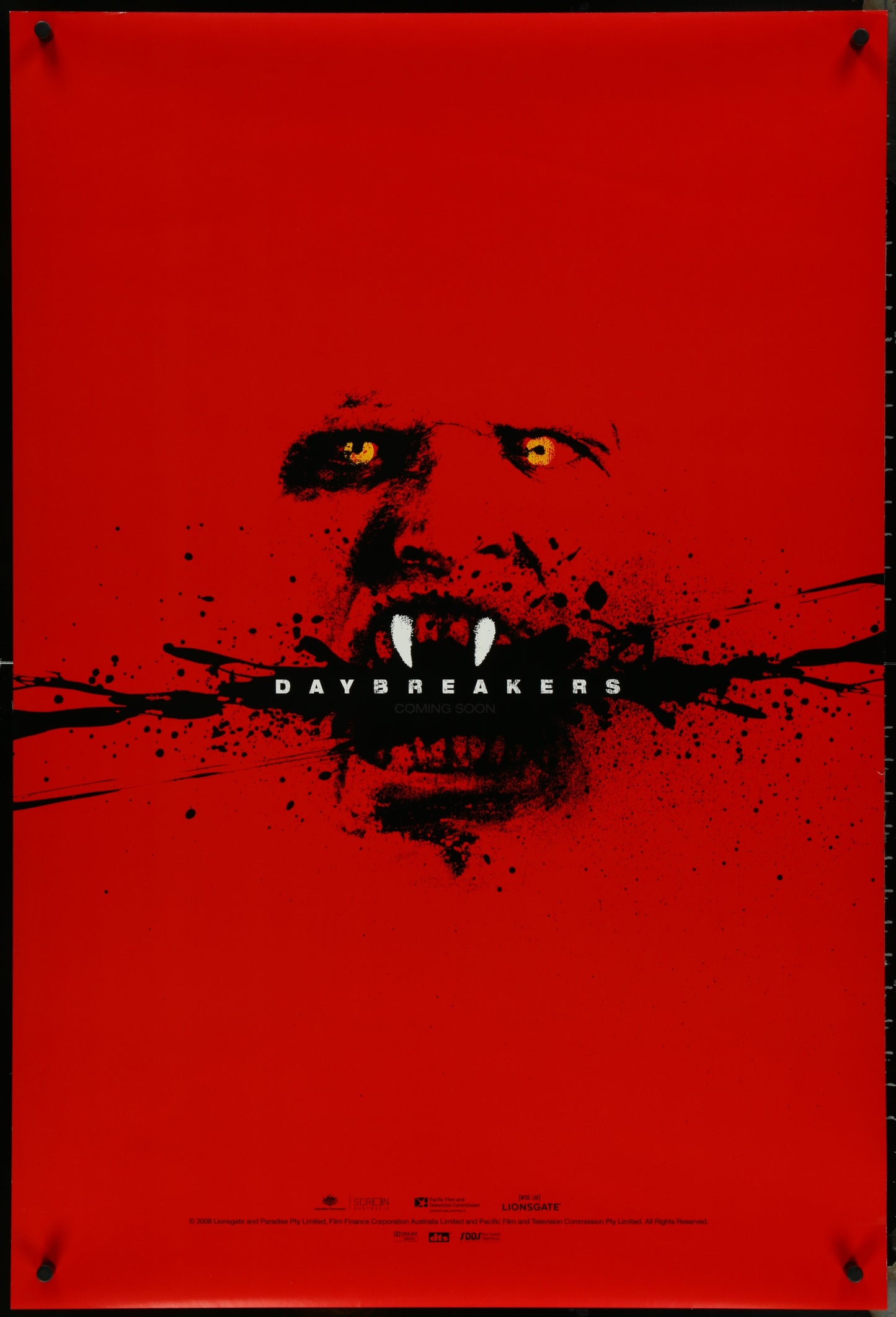 Double-sided, unfolded original teaser one-sheet movie poster for the film 'Daybreakers' featuring a red background and a close-up of a character's face with a feral expression.