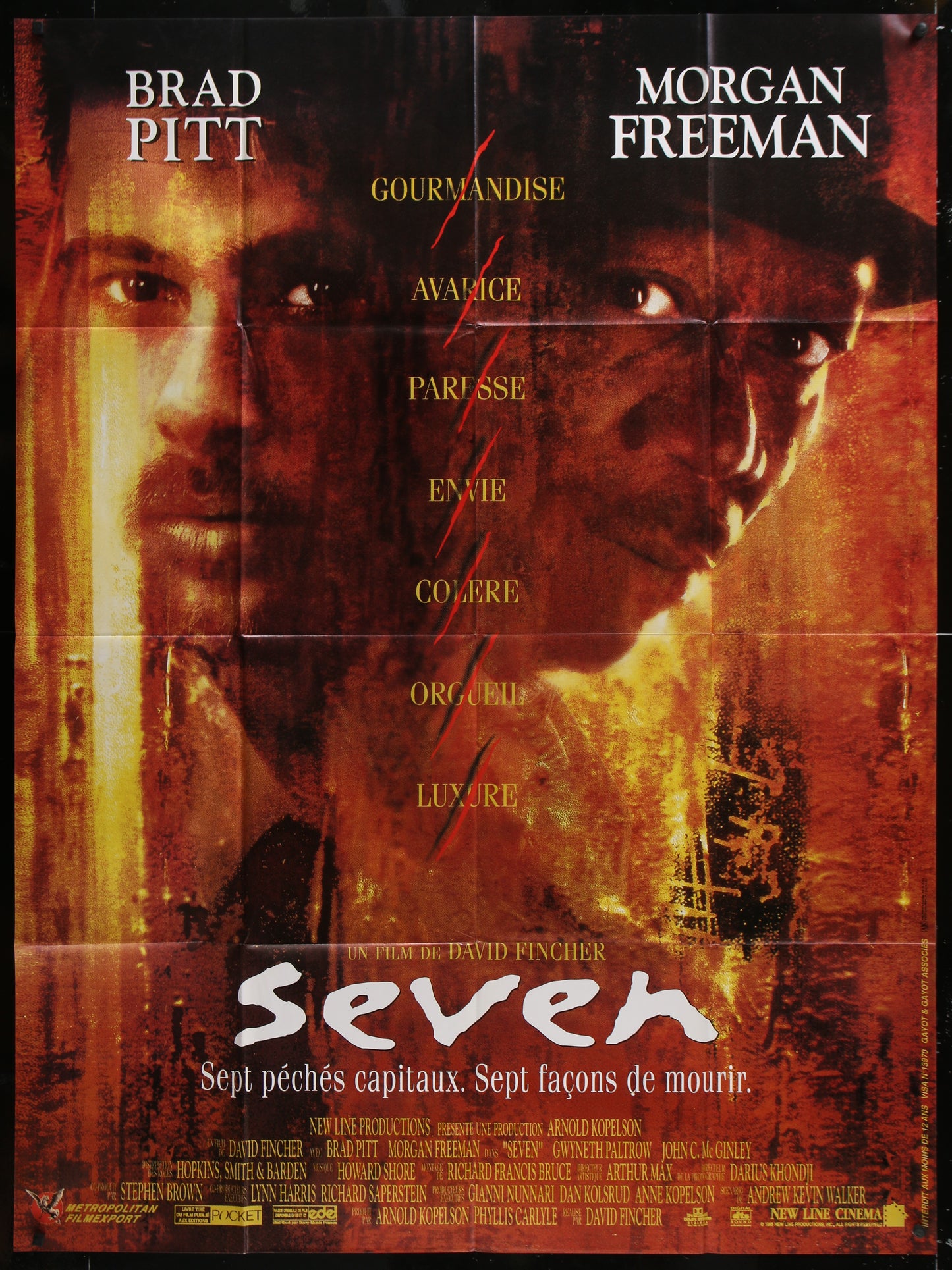 Movie poster for 'Seven' featuring Brad Pitt and Morgan Freeman with a red and orange color scheme.