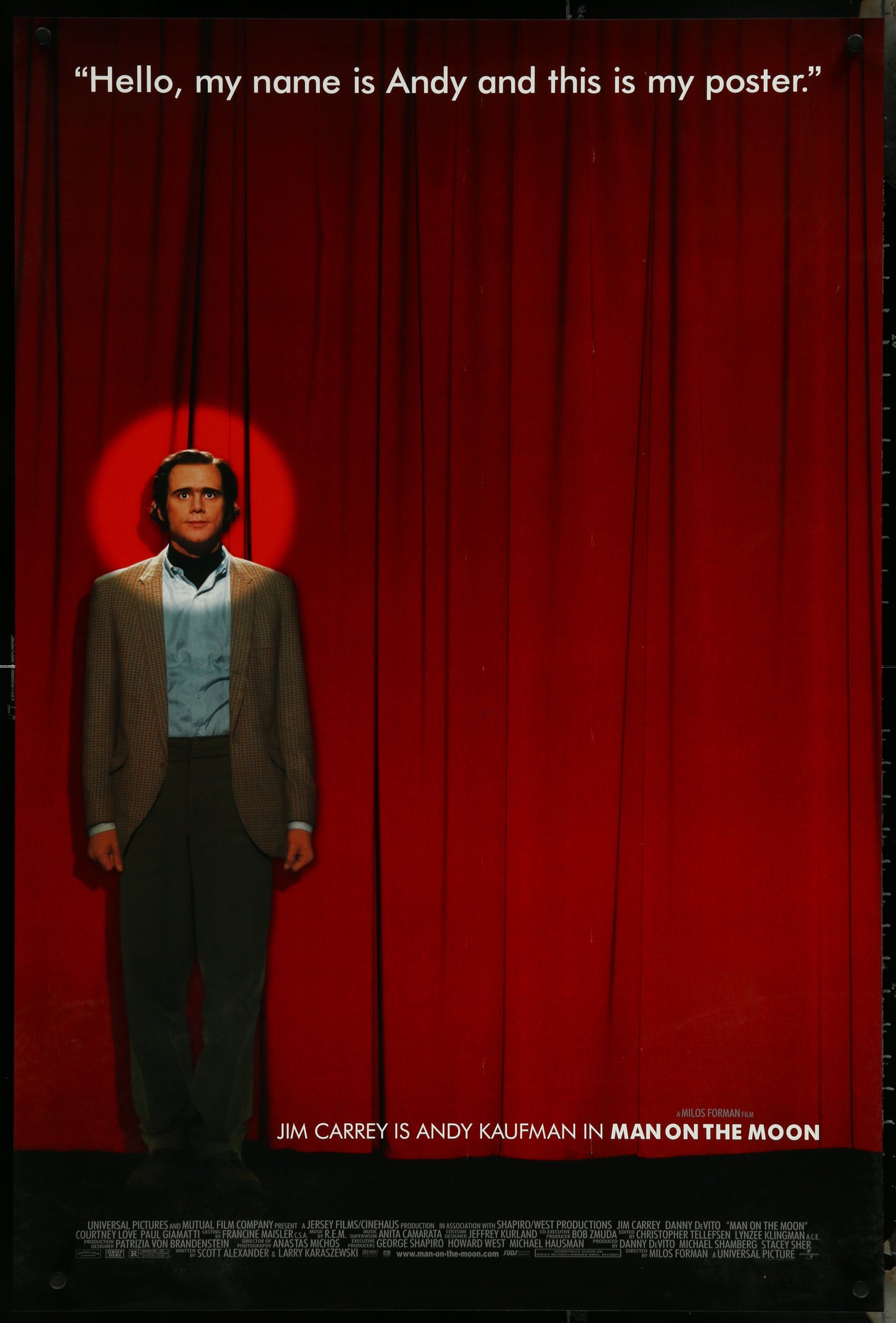 The image displays an original one-sheet movie poster for the 1999 film "Man On The Moon." The poster features a striking portrait of Jim Carrey, who plays the role of Andy Kaufman, against a vibrant red background.