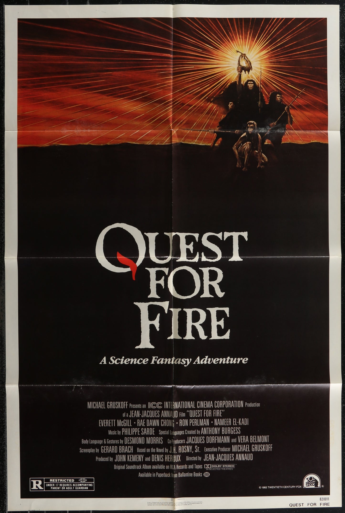 Movie poster for 'Quest for Fire' with a dramatic sunset scene and text.