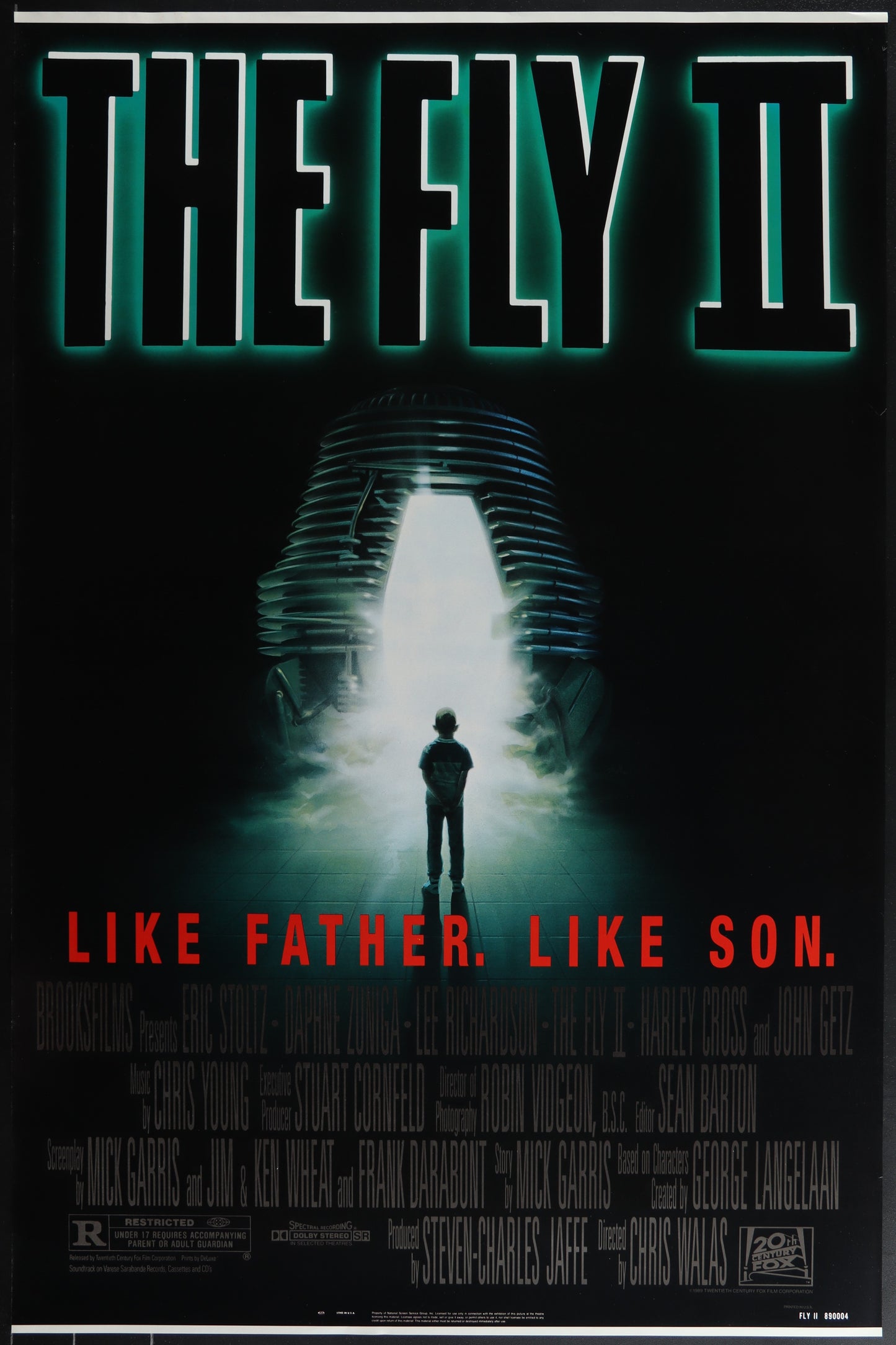 The Fly II movie poster featuring a silhouette of a person standing in front of a glowing structure, with the tagline 'LIKE FATHER. LIKE SON.