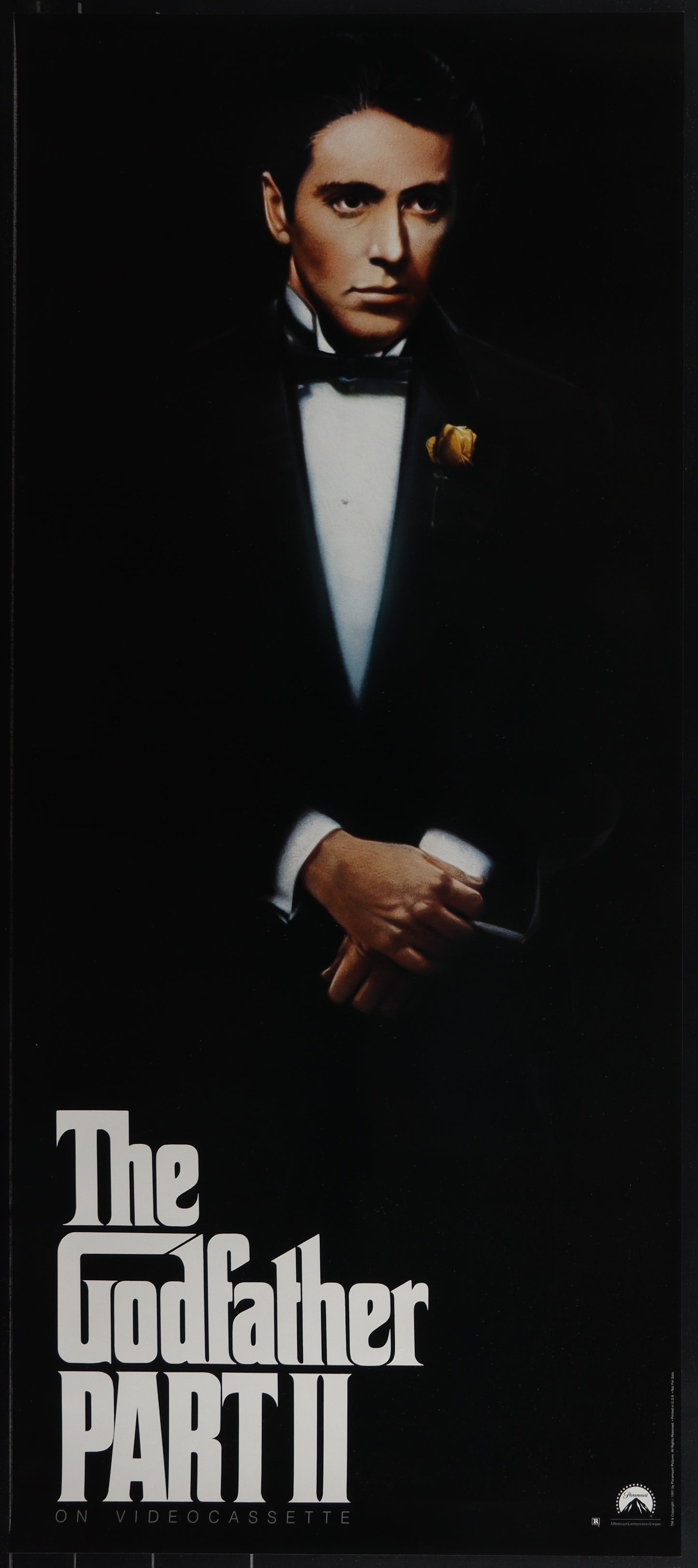 Original video poster for The Godfather Part II featuring an image of a man in a tuxedo, title text, and minor decorative elements.
