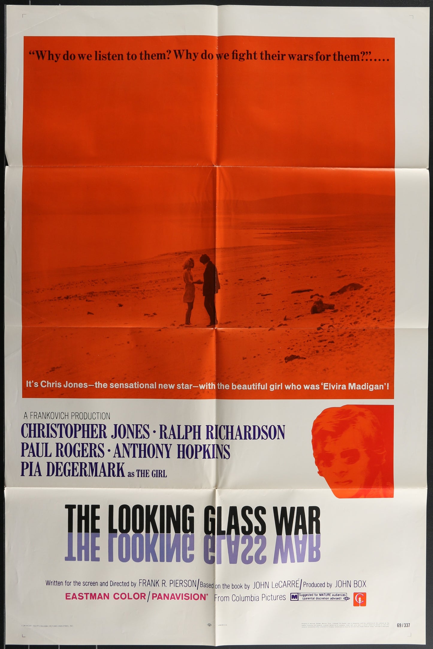 Vintage one-sheet movie poster for 'The Looking Glass War' featuring a man and a woman on a beach at sunset, with the movie title and cast names below.