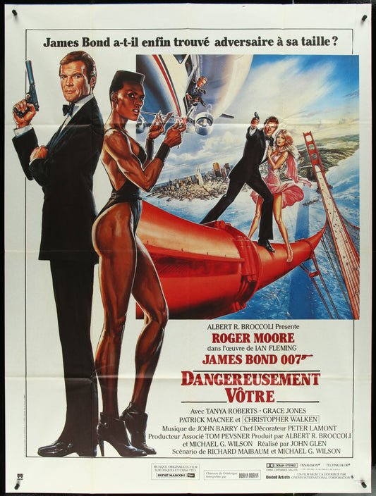 A vintage French one-panel movie poster for the 1985 James Bond film 'A View to a Kill', featuring characters played by Roger Moore and Christopher Walken, with a red and blue design predominantly.