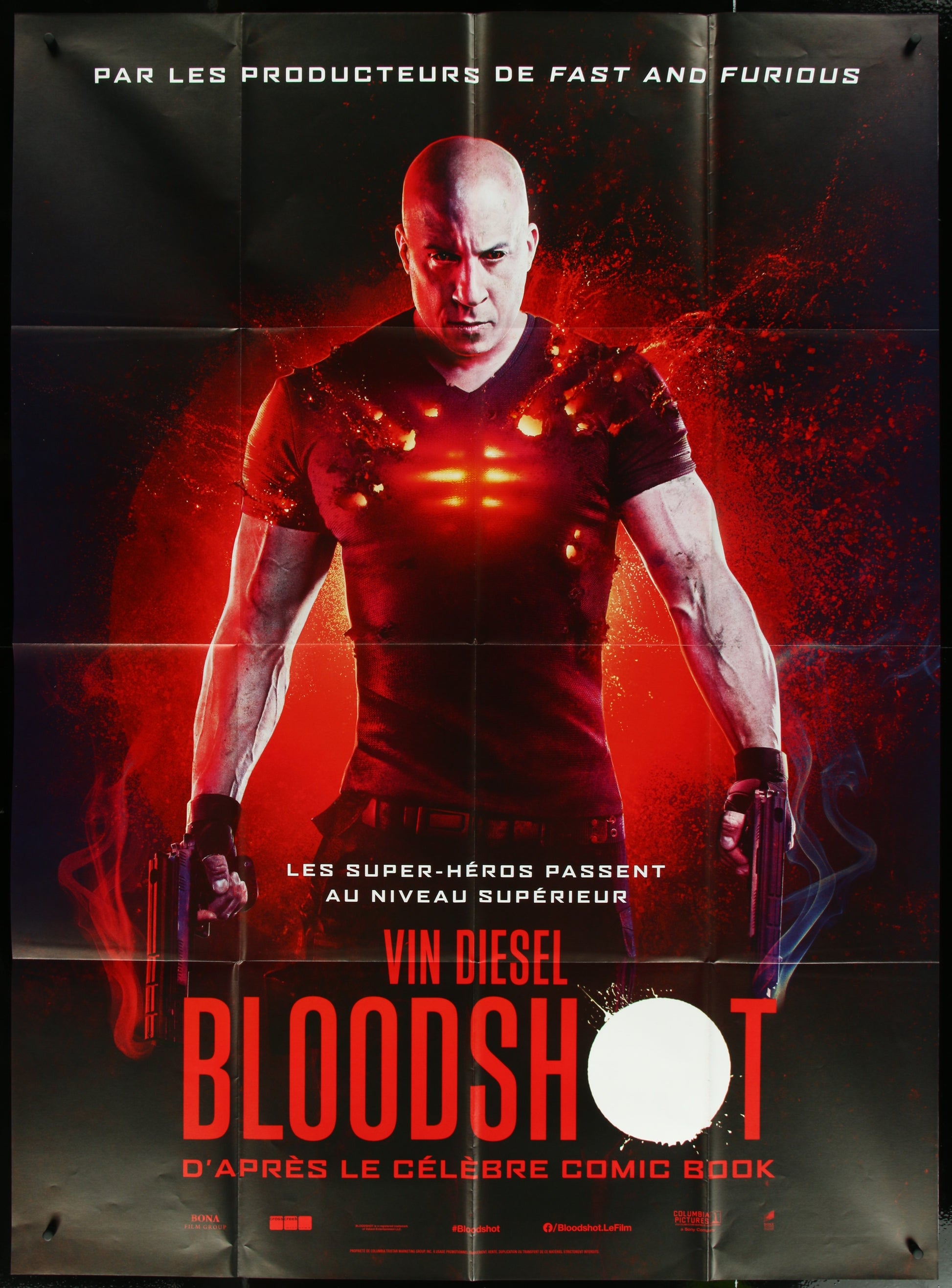 A movie poster featuring Vin Diesel with a red and black color scheme, indicating a superhero action thriller genre.