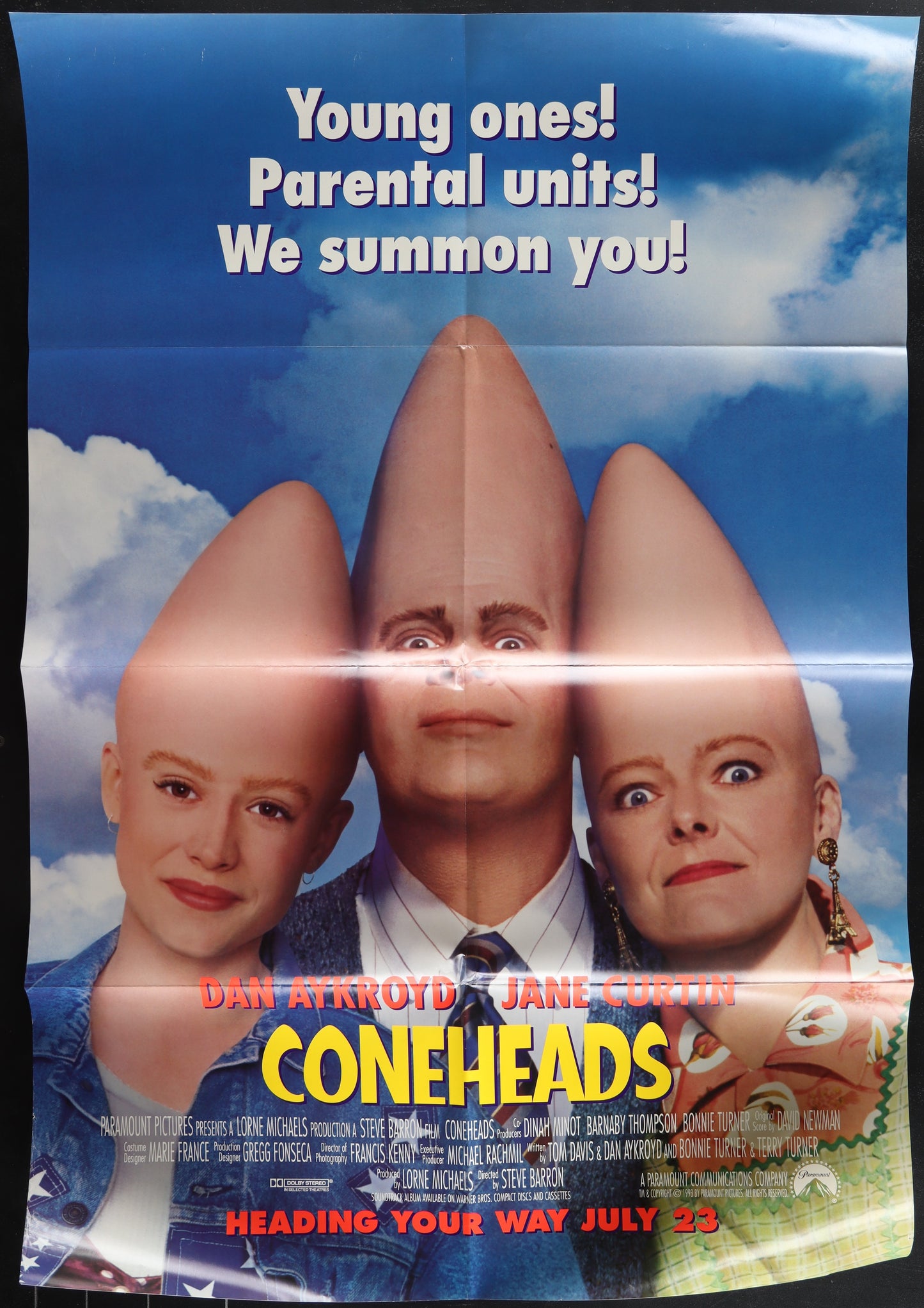 Movie poster for 'Coneheads' with three characters with cone-shaped heads against a blue sky.