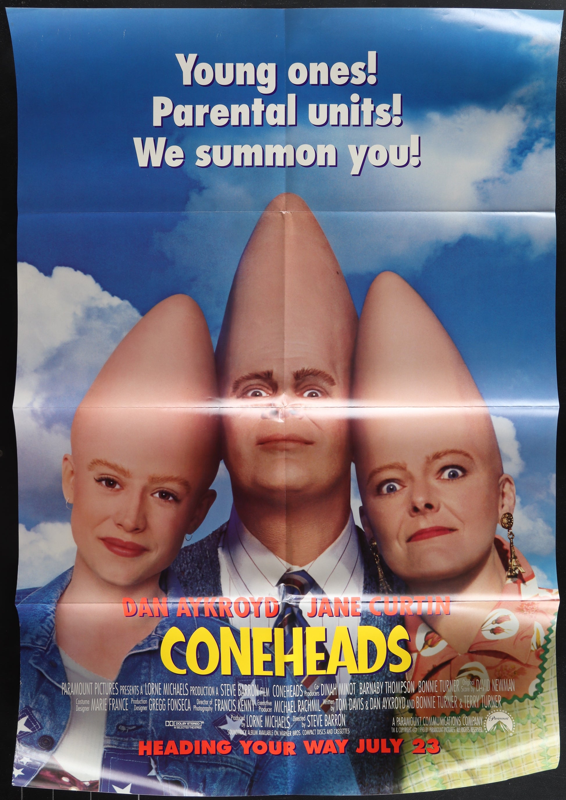 Movie poster for 'Coneheads' with three characters with cone-shaped heads against a blue sky.