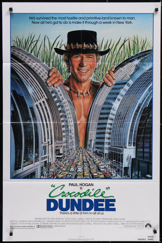Crocodile Dundee movie poster featuring a man with a hat over his face peeking from behind a building, with a cityscape background.