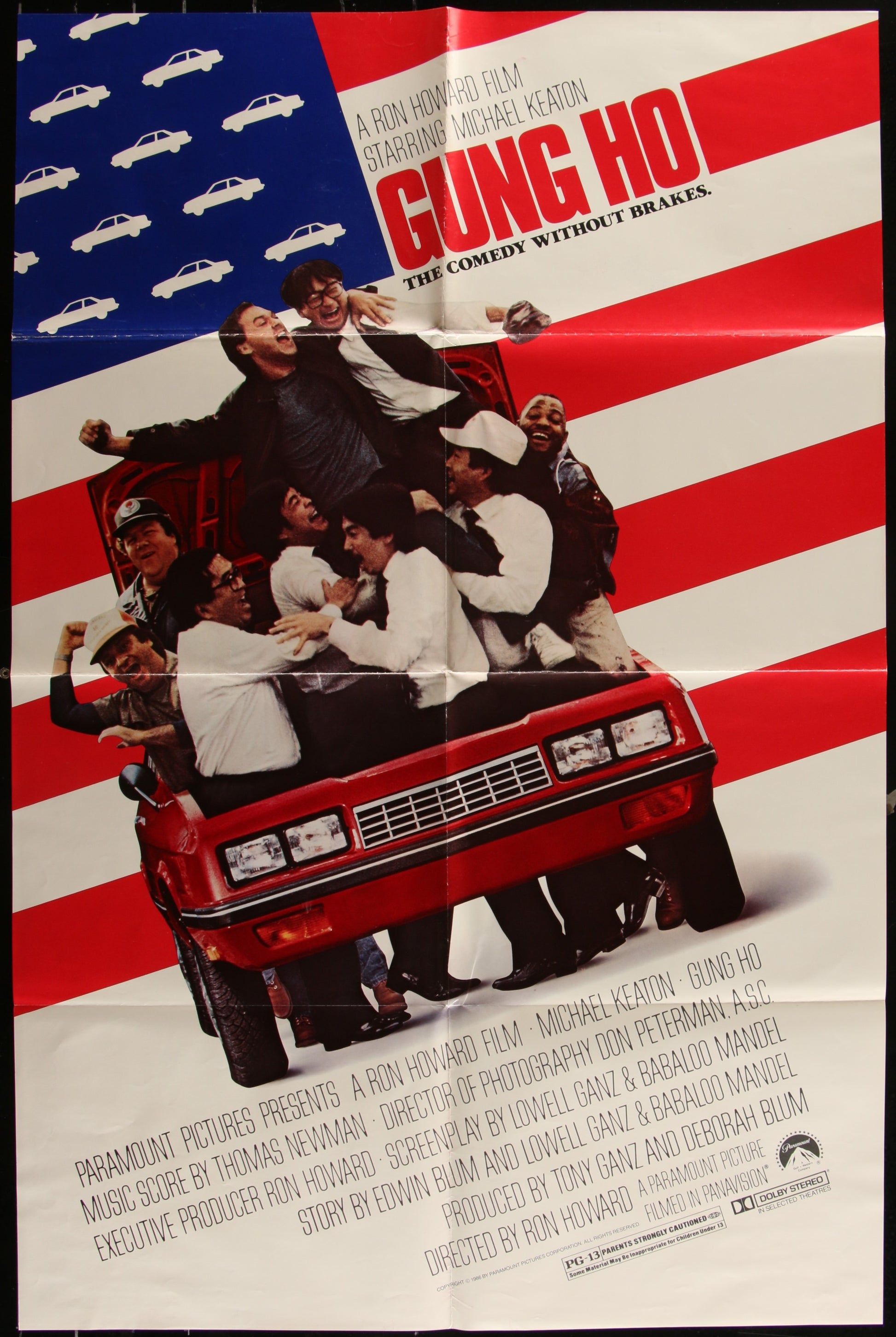 Vintage movie poster for 'Gung Ho' featuring a group of people on a red car with a background of an American flag.