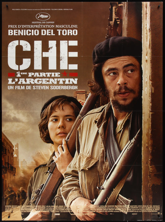 A movie poster for 'Che - Part 1' featuring two characters prominently with guns, indicative of the film's theme and setting.