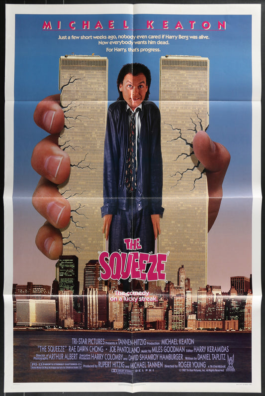 "Original US one sheet movie poster for The Squeeze (1987). Action comedy thriller starring Michael Keaton and Rae Dawn Chong. Vintage folded poster (27 x 41 inches) featuring Keaton and Chong in dramatic pose against New York City backdrop. Minor wear on fold lines and edges consistent with age. Classic 80s crime film collectible.