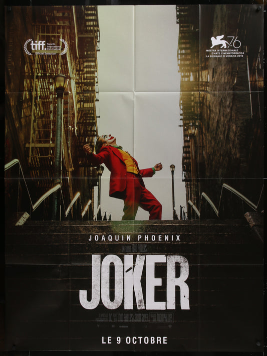 Movie poster for 'Joker' featuring Joaquin Phoenix in a red suit against a cityscape.