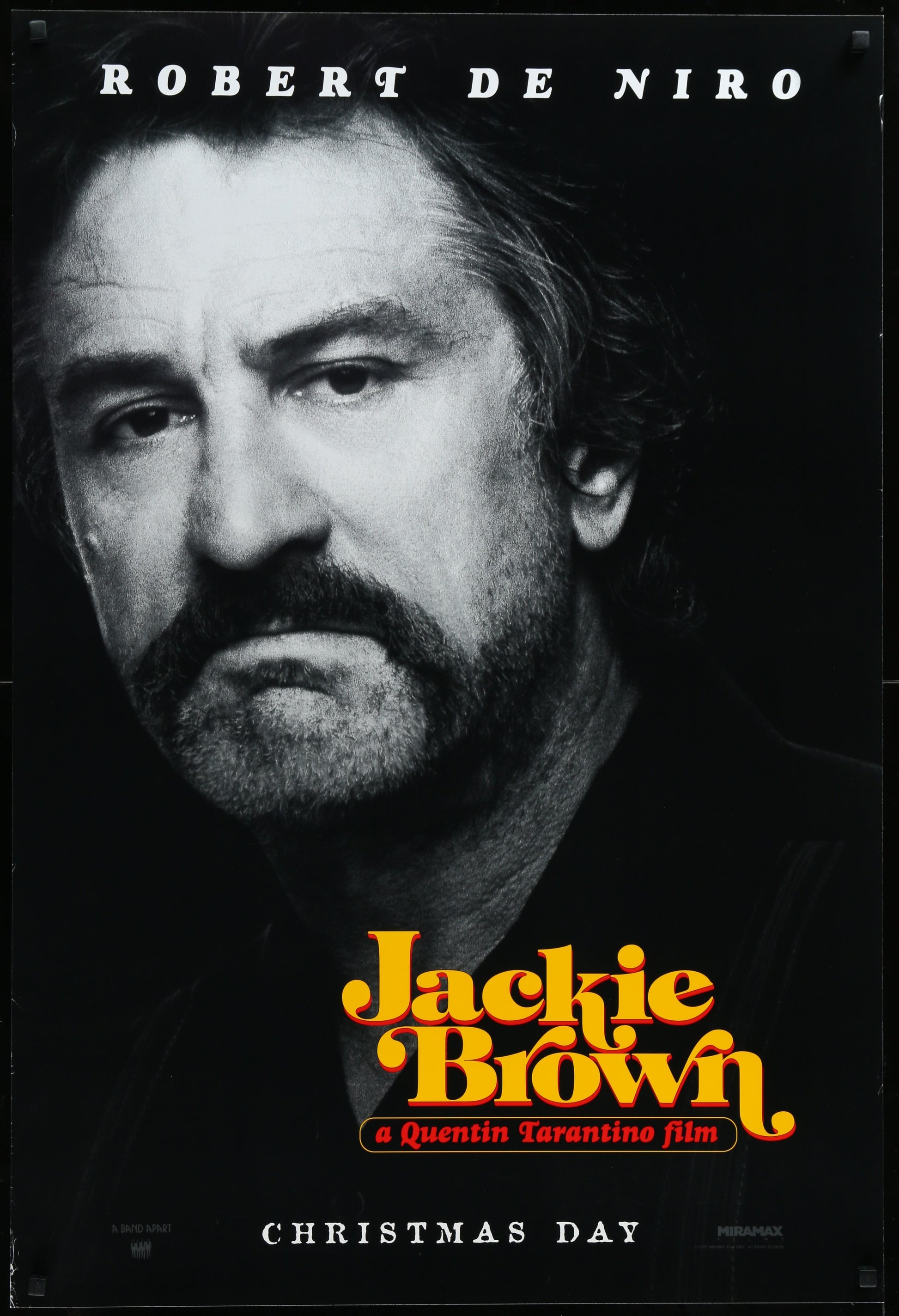 A vintage one-sheet movie poster for 'Jackie Brown' featuring a black and white image of the Robert De Niro with actors' names listed below.