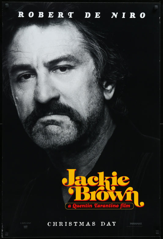 A vintage one-sheet movie poster for 'Jackie Brown' featuring a black and white image of the Robert De Niro with actors' names listed below.