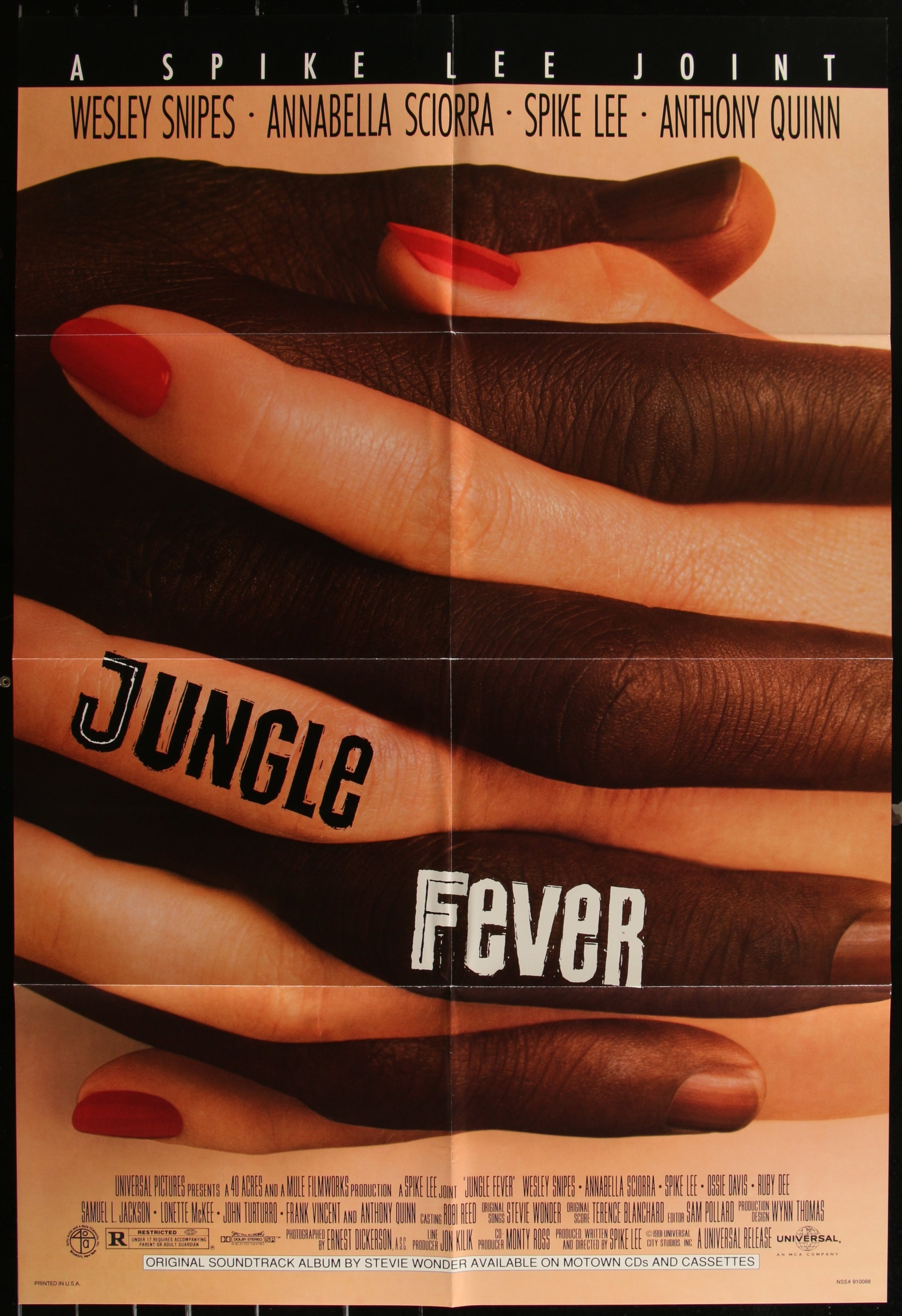 A vintage movie poster for 'Jungle Fever' featuring a close-up of a character's hand with the title written across the fingers.