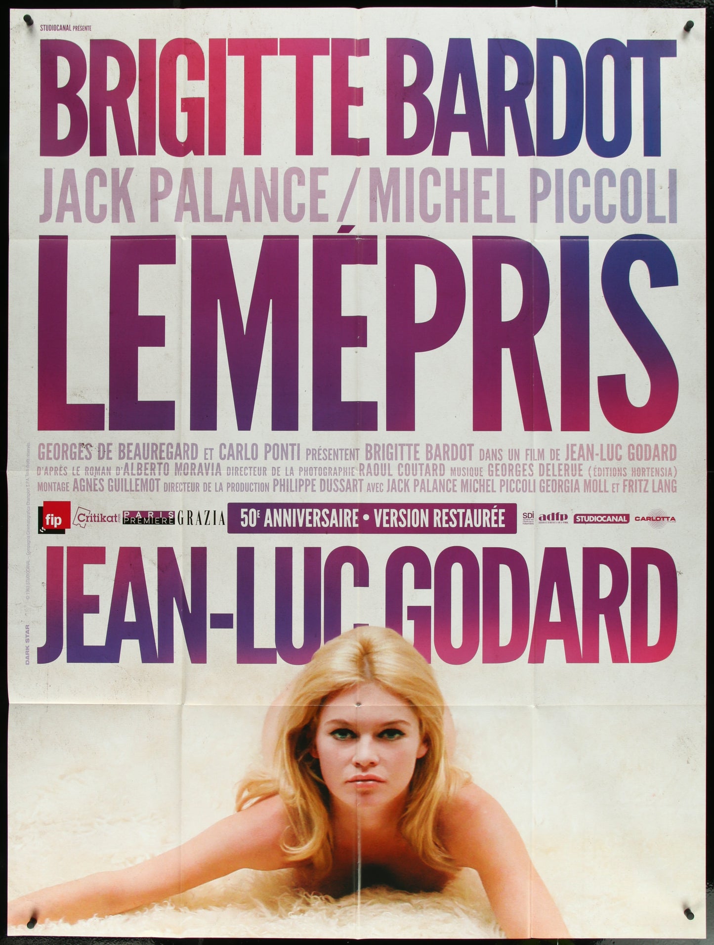 A vintage style movie poster featuring a woman with blonde hair, likely Brigitte Bardot, in a vibrant, multicolored design, announcing the film 'Le Mepris' with text and credits.