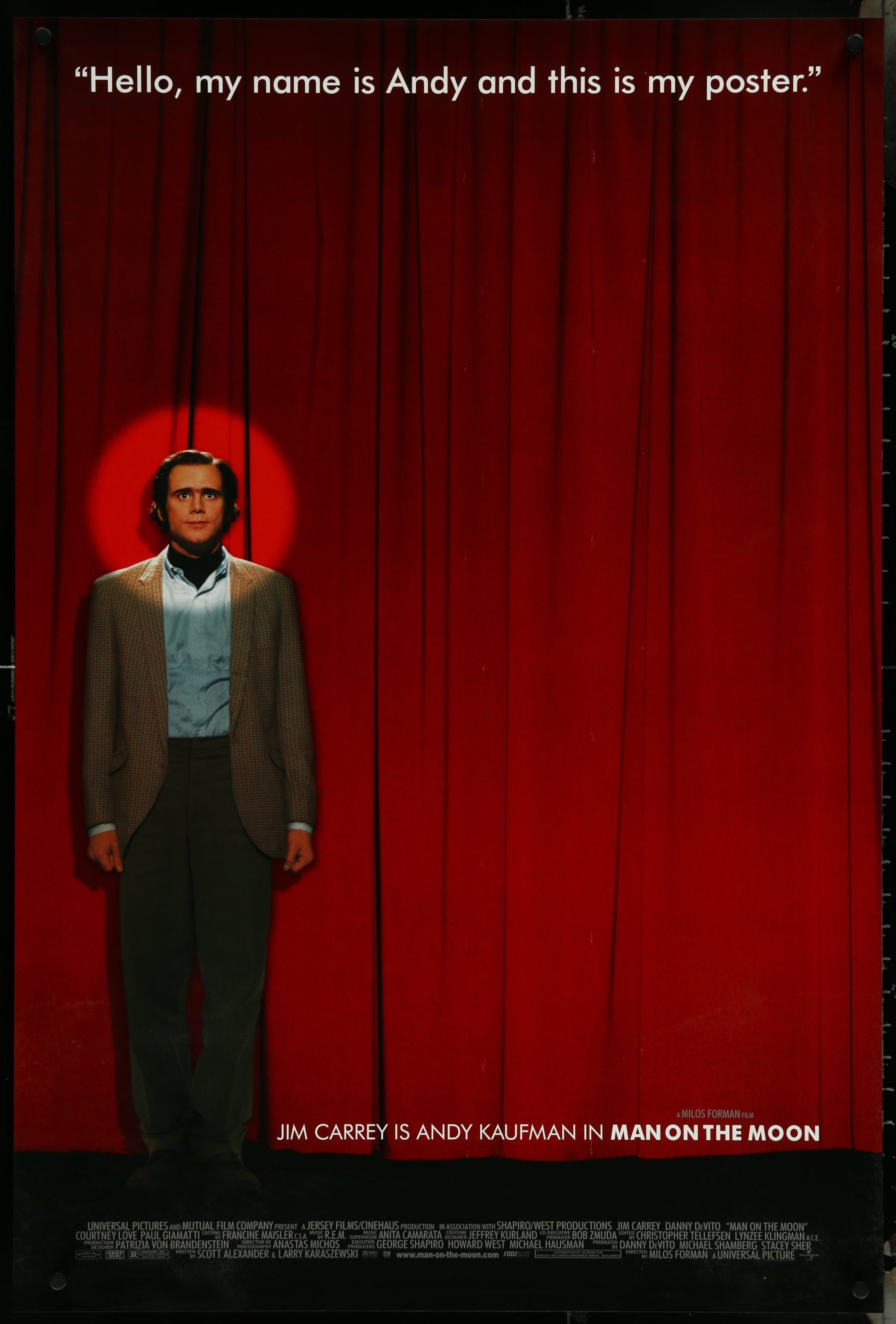 The image displays an original one-sheet movie poster for the 1999 film "Man On The Moon." The poster features a striking portrait of Jim Carrey, who plays the role of Andy Kaufman, against a vibrant red background.