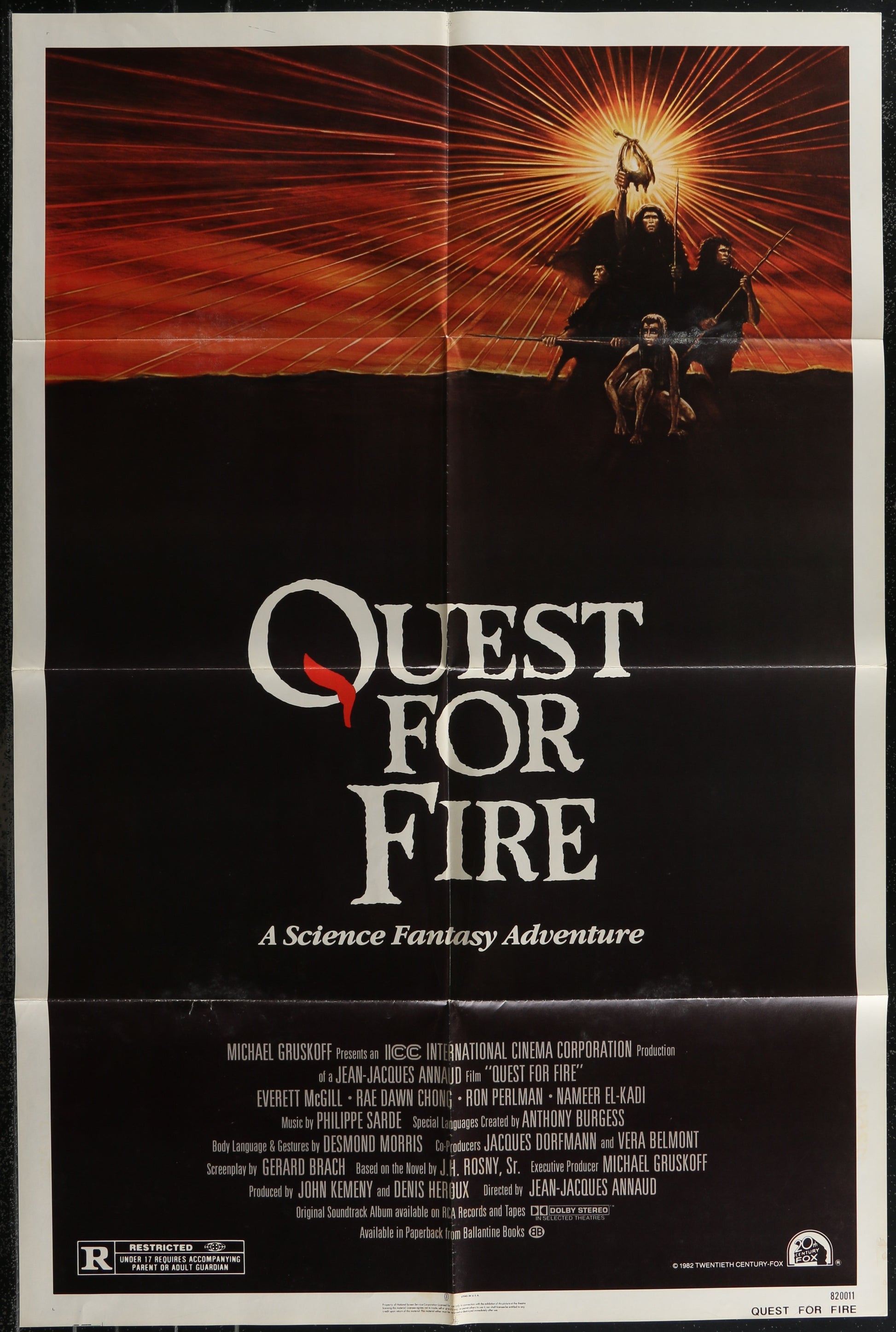 Movie poster for 'Quest for Fire' with a dramatic sunset scene and text.