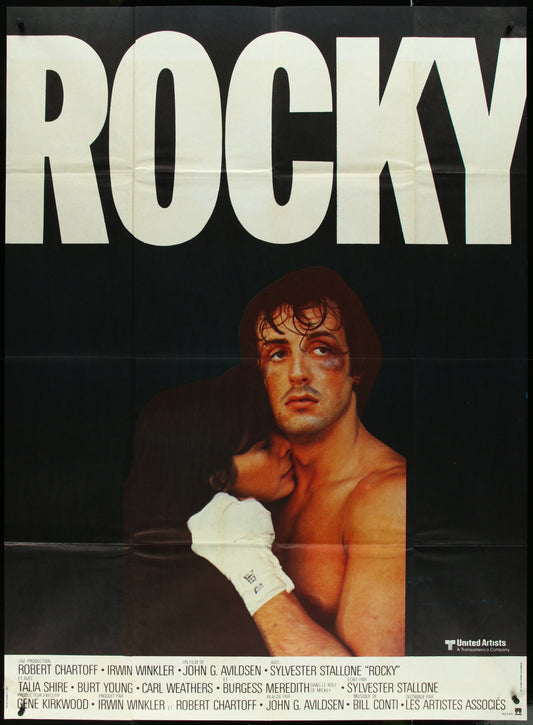 A vintage French one-panel movie poster for the film 'Rocky', featuring an image of Sylvester Stallone and Talia Shire with the title 'ROCKY' prominently displayed at the top.