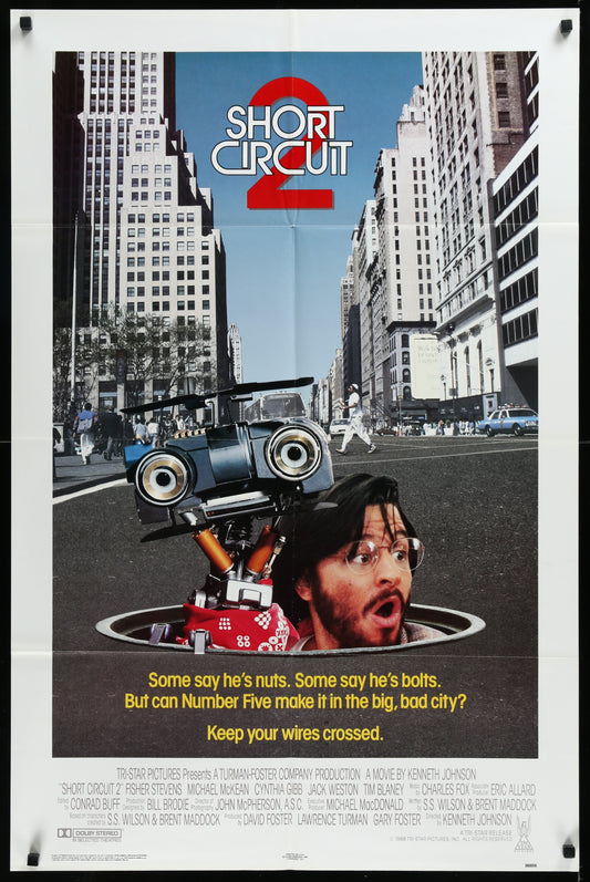 Original US one-sheet movie poster for 'Short Circuit II' featuring an image of the main character in a car, with a cityscape background, and text including the movie title and a quote.