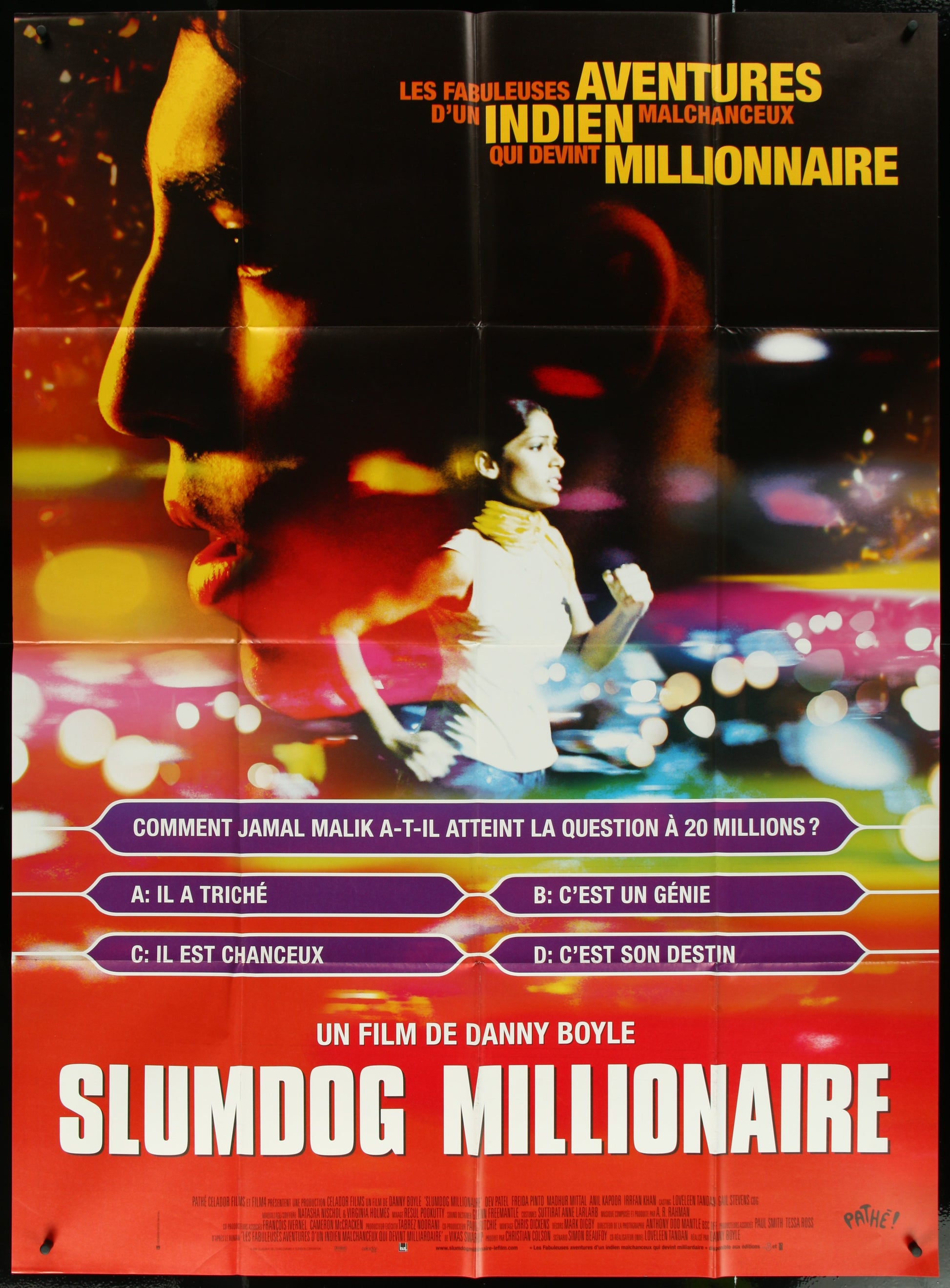 A vintage French movie poster for 'Slumdog Millionaire' featuring a man and a woman in a blurred cityscape background.