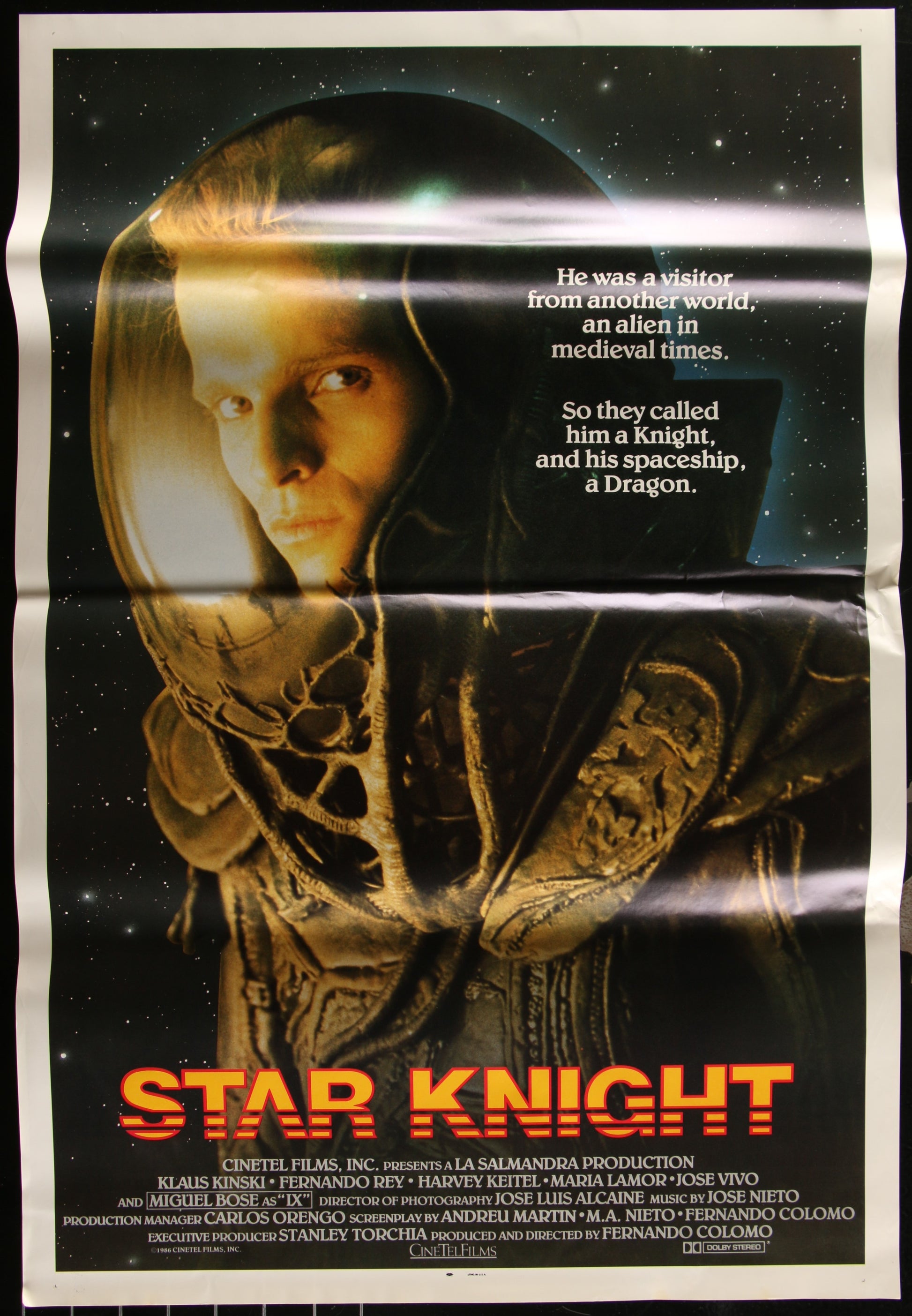 A one-sheet movie poster for the 1985 film Star Knight, featuring an image of a character in space suit against a cosmic background, with horizontal creases and waves.