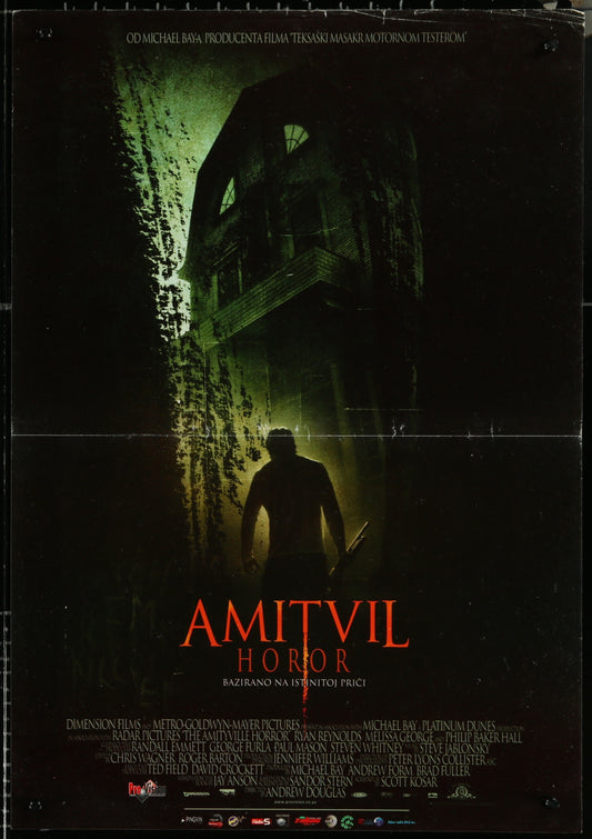 Vintage movie poster for 'Amityville Horror' featuring a dark, eerie image of a house at night with a silhouetted figure in the foreground.