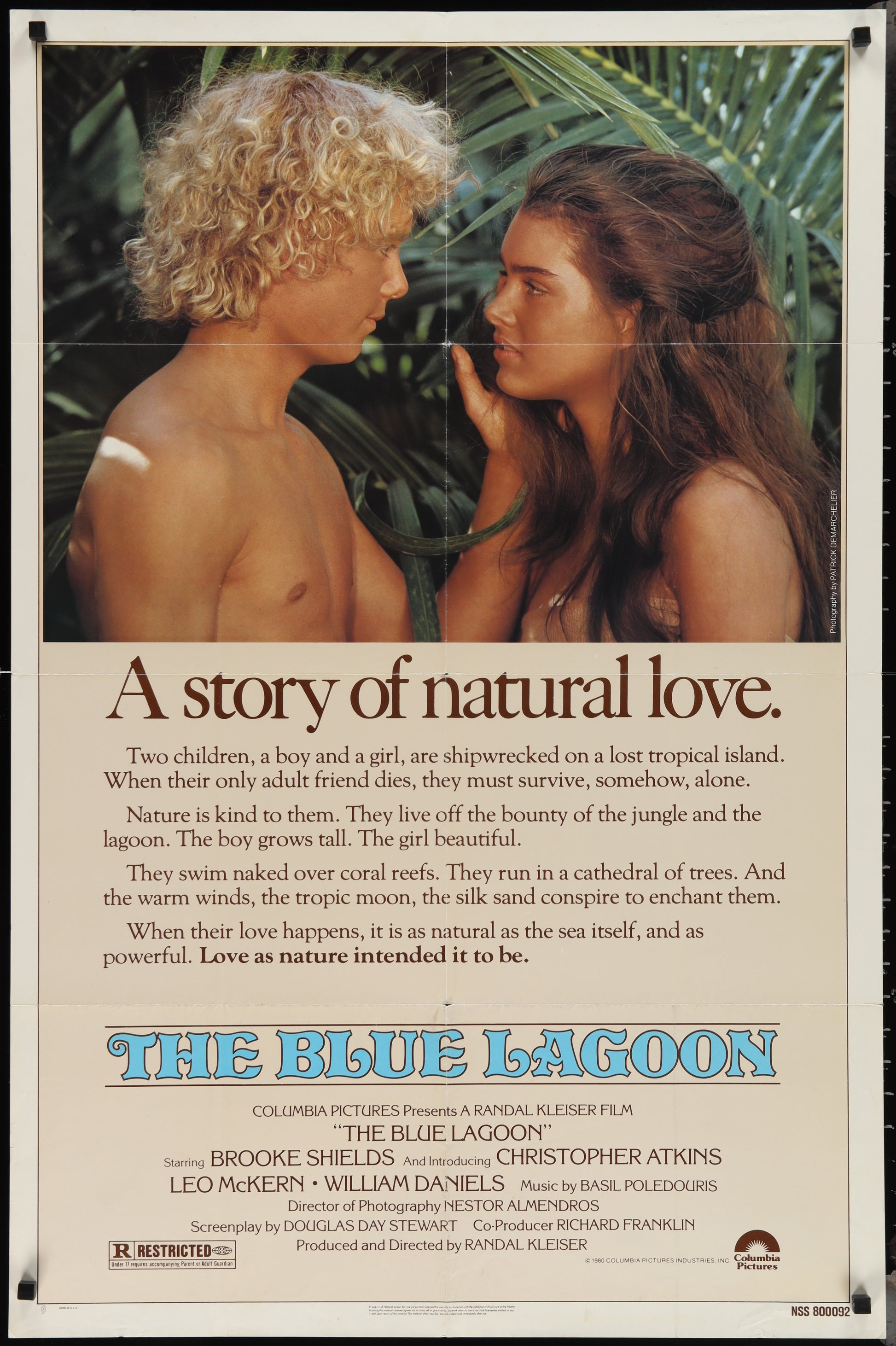 Vintage movie poster for 'The Blue Lagoon' featuring two people on the beach, with text detailing the film's title and a brief description.