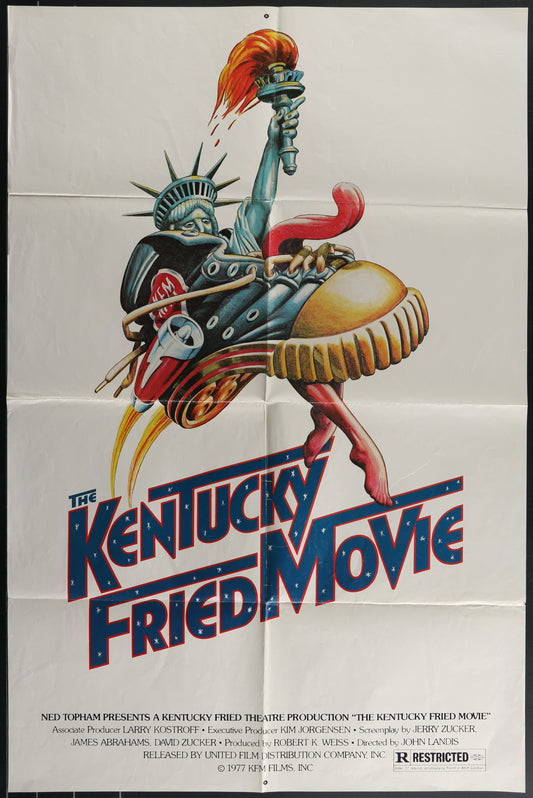 Vintage style movie poster for 'The Kentucky Fried Movie' featuring a stylized illustration of a character with a chicken-themed helmet and a bucket of chicken, against a red and blue background.