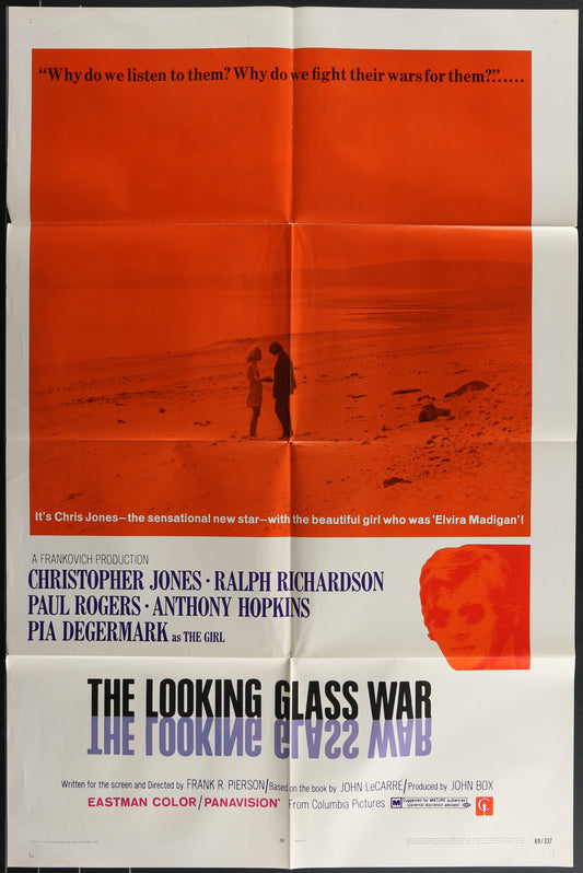 Vintage one-sheet movie poster for 'The Looking Glass War' featuring a man and a woman on a beach at sunset, with the movie title and cast names below.