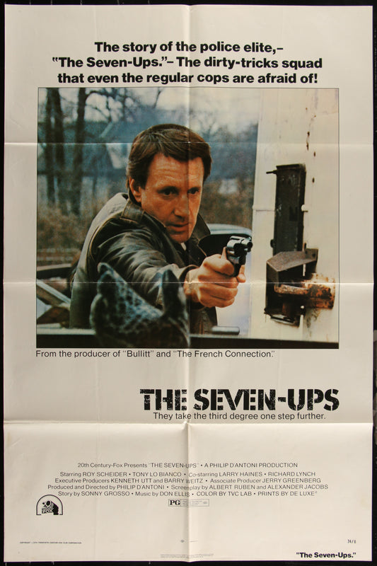 The image displays an original US one-sheet movie poster for the 1974 crime thriller "The Seven-Ups." Directed by Philip D'Antoni and starring Roy Scheider, the poster features a striking depiction of Scheider with a gun, emphasizing the film's action-packed and police-themed narrative.