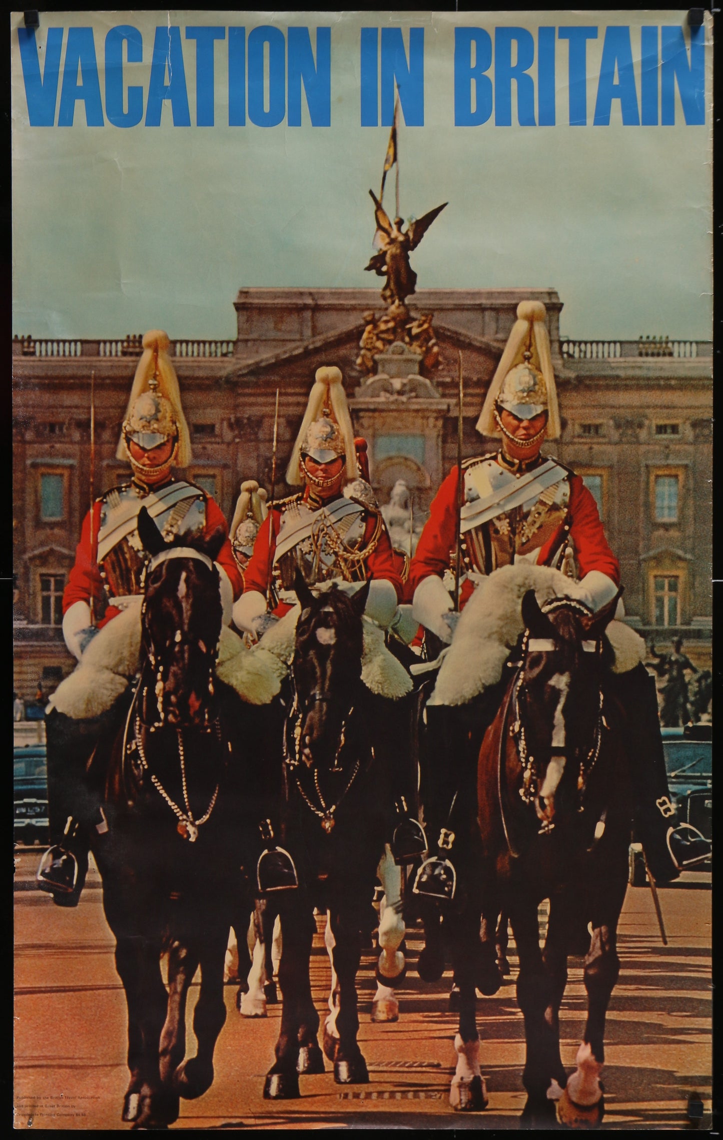 Vintage travel poster for 'Vacation in Britain' featuring guards on horseback in front of a building.