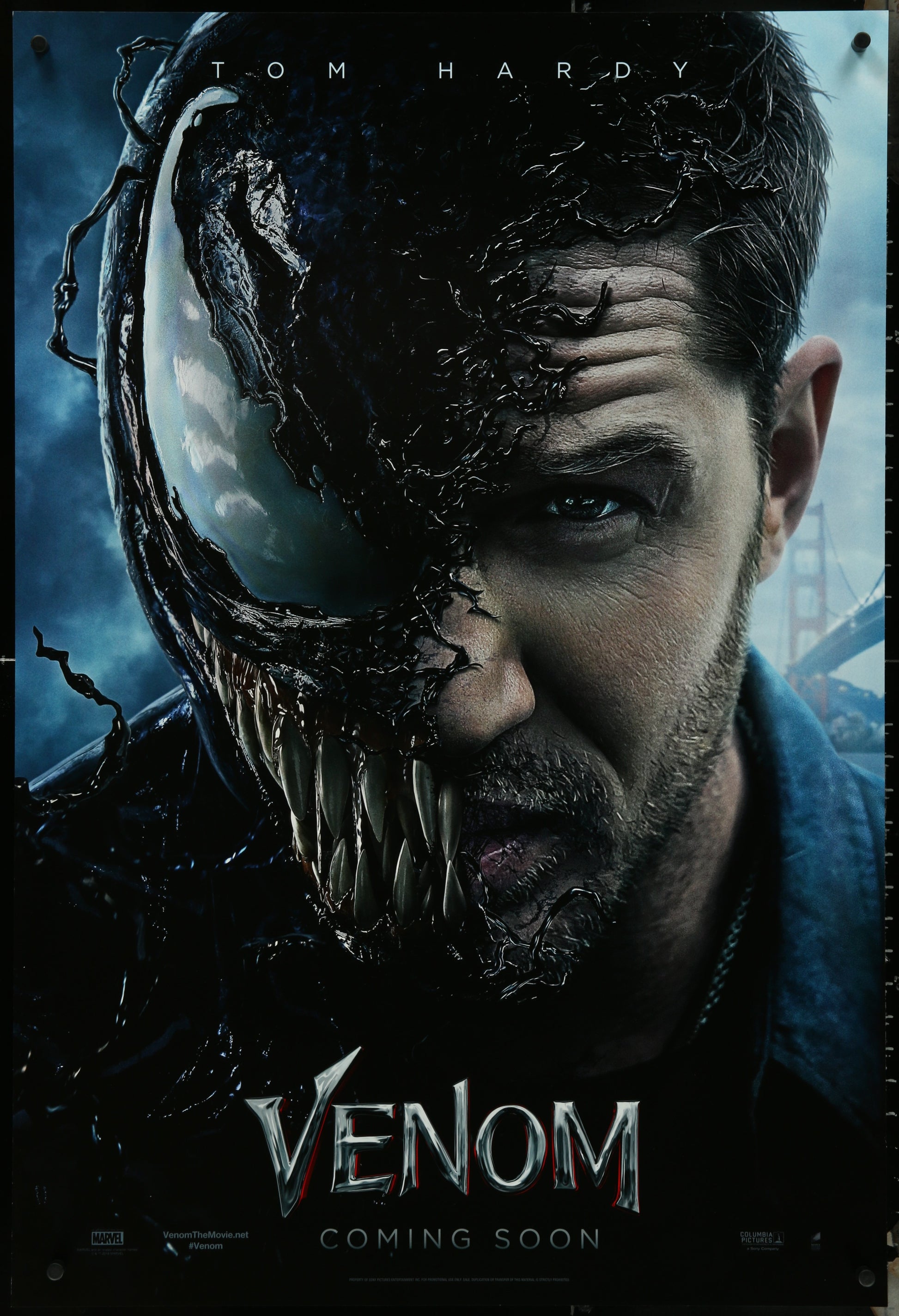 A promotional movie poster for 'Venom' featuring a split image of the character Venom with a human face in the foreground, set against a dark background. The poster has a caption that reads 'VENOM' and 'ON HARDY' with a release date at the bottom.