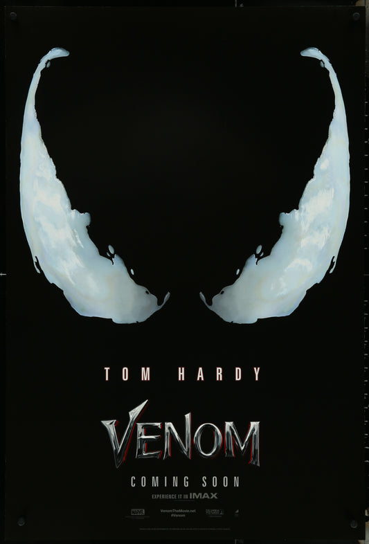 A promotional one-sheet movie poster for the film Venom, featuring the character's mask in the foreground with the title and 'Coming Soon' text in the background.
