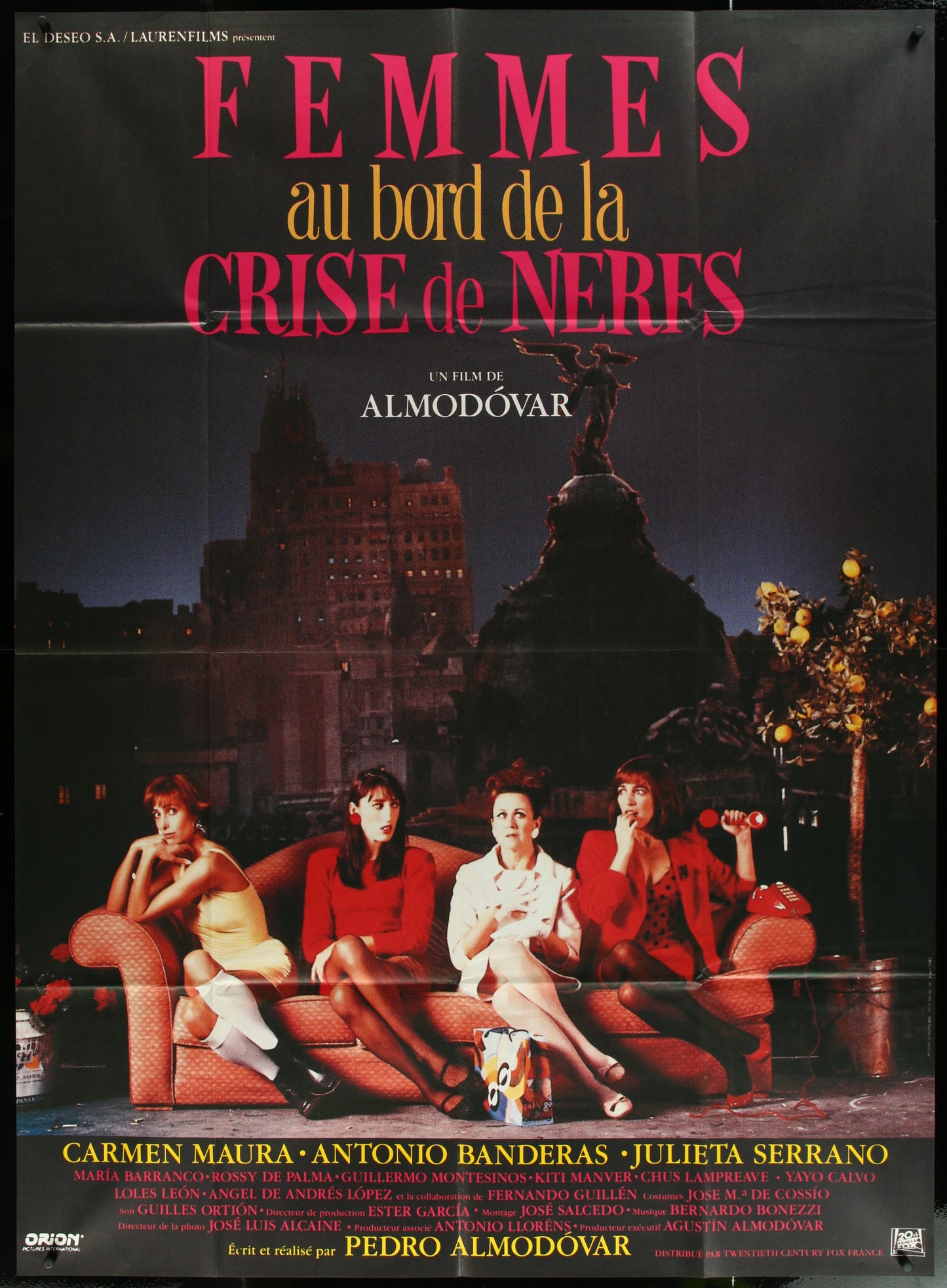Vintage French one-panel movie poster for 'Women On The Verge Of A Nervous Breakdown' featuring three women sitting in a room with a window view of a cityscape at night.