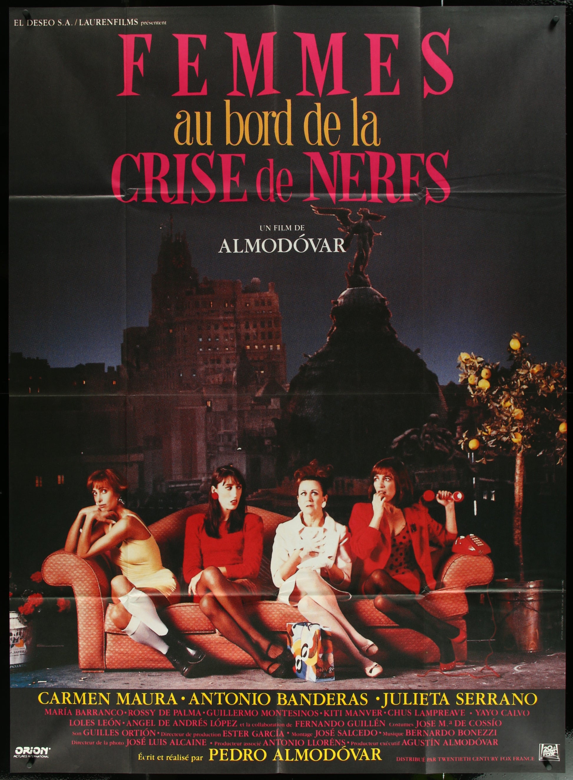 Vintage French one-panel movie poster for 'Women On The Verge Of A Nervous Breakdown' featuring three women sitting in a room with a window view of a cityscape at night.